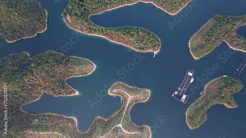 Aerial view of thousands of islands in Qiandaohu lake in Chunan, Hangzhou, Zhejiang, China. Colorful islands and peaceful lake, beautiful natural landscape, 4k real time footage, drone view. photo