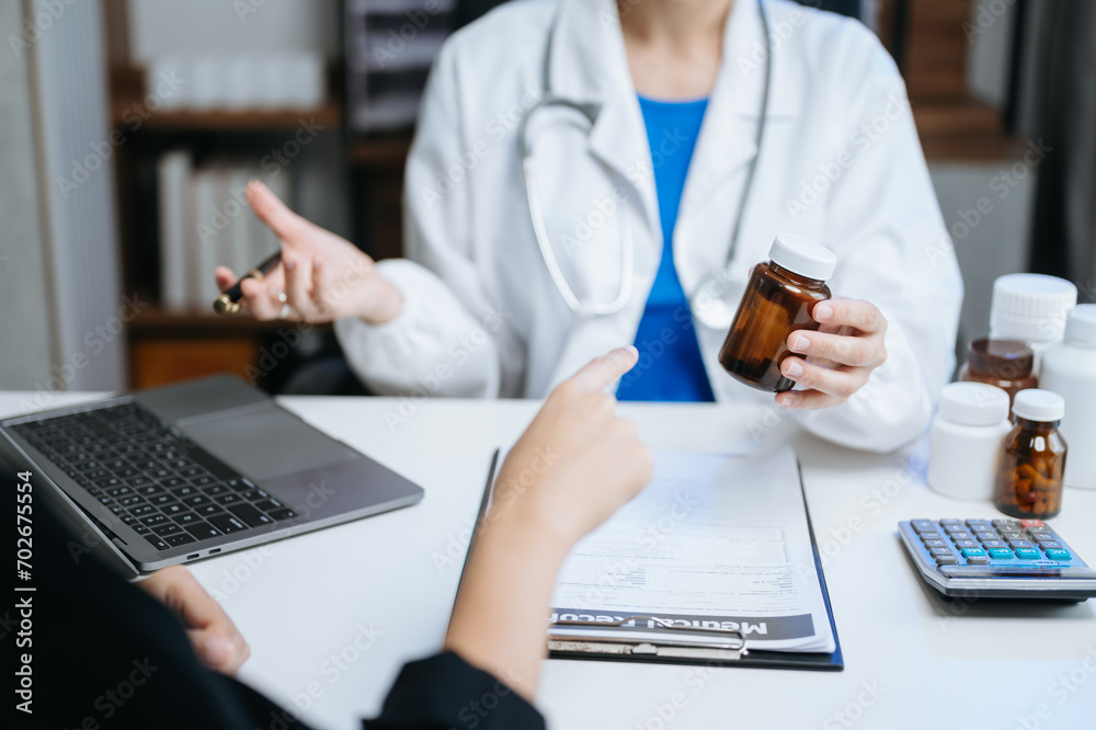 Healthcare costs and fees concept.Hand of smart doctor used a calculator and smartphone, tablet for medical costs Healthcare costs and fees concept.Hand of smart doctor used a calculator and smartphone, tablet for medical costs