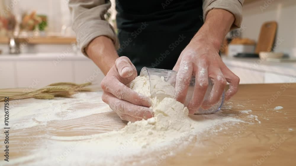 A cook in the kitchen sifts flour through a sieve. Kneading raw dough with male hands. Breaks an egg. White flour. A cook in the kitchen sifts flour through a sieve. Kneading raw dough with male hands. Breaks an egg. White flour.