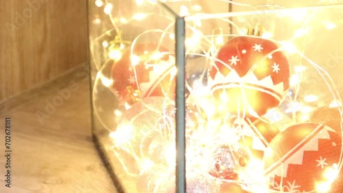 Turning on a garland with yellow lights for New Year's Eve or Christmas Day