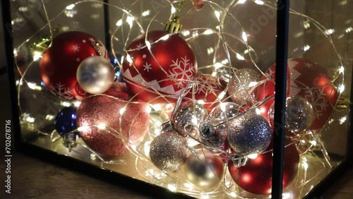 Red New Year's Eve balloon take hands to correct it in a decorated New Year's Eve aquarium