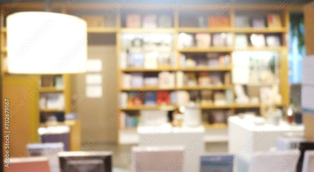 Blur background of book shelf store decorated with wood and warm light