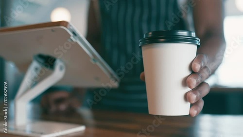 Cashier hands, coffee cup and counter for service, cafe order and offer in customer POV at point of sale. Waiter, barista or worker on digital technology for menu and giving drink or latte to person photo