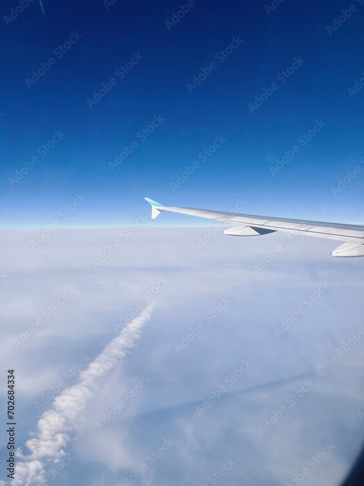 airplane wing clouds cruise another plane