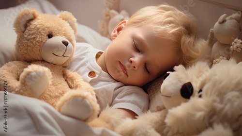 A little boy with blonde hair sleeps on a bed with a soft toy bear in her arms. A child's sweet sleep