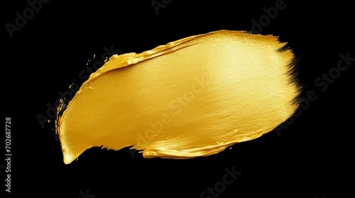 Beautiful textured golden brush stroke on black background. Luxurious and shiny gold paint stroke. photo