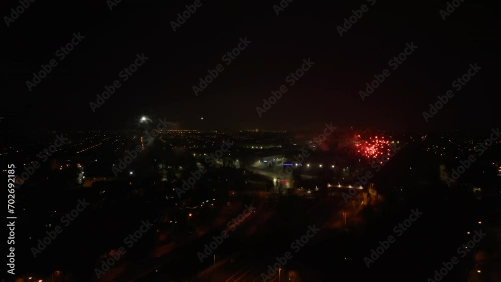 Aerial drone night video of a fireworks show with dazzling colors glowing over the city. Aerial drone night video of a fireworks show with dazzling colors glowing over the city.