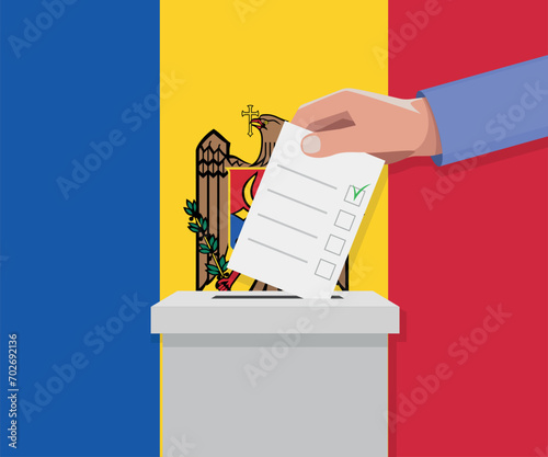 Moldova election concept. Hand puts vote bulletin