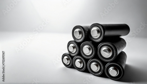 AI-generated illustration of cylindrical batteries arranged in a stack on a white surface