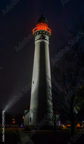 Windpoint Lighthouse illuminated by a bright red light at night