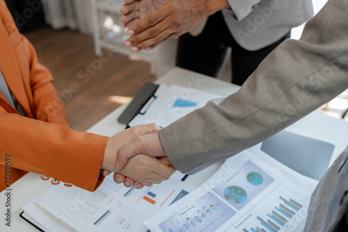 Meeting commitments in a meeting room at the office, Business people shaking hands in office, Shot of a businessman and businesswoman shaking hands, Handshake in contemporary office space,