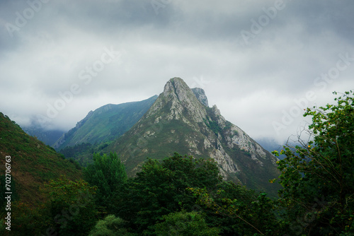 Fotografie Stunning landscape of Asturias, Spain with green mountains against a cloudy sky