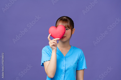 Heart. Love symbol. Portrait of beautiful happy woman hold Valentine day symbol.