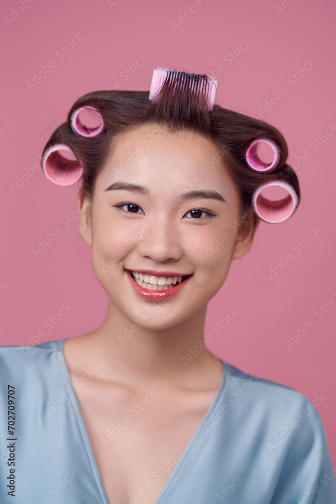 beautiful asian woman with a curler in her hair