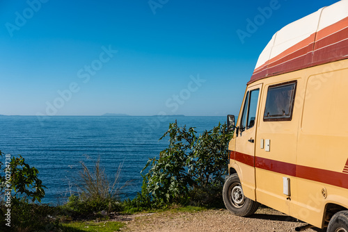 Motor homes, camper vans at sunset beach. Travel adventure vacation concept background.