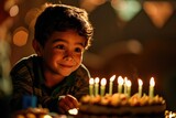 A joyful boy eagerly awaits his birthday wish as he smiles at the delectable cake adorned with flickering candles and intricate decorations