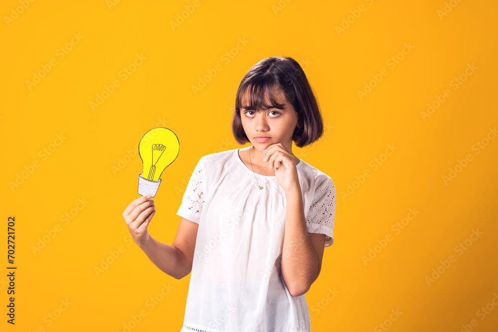 Child girl holding paper bulb. Success, motivation, winner, genius, idea concept Child girl holding paper bulb. Success, motivation, winner, genius, idea concept