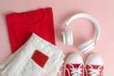 Red and pink lifestyle theme in flat lay concept. Must have item for daily life: smartphone, headphone, shoes and sunglasses.