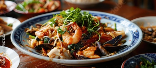 Spicy stir-fried seafood including clams.