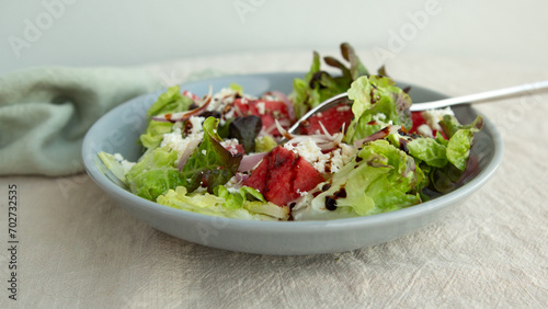 plate with salad with watermelon and feta cheese on the table