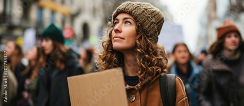 Woman holds a cardboard with a message supporting animal rights at a protest march. © 2rogan