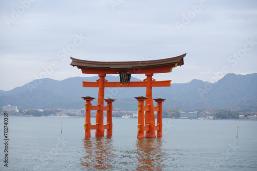 Miyajima Island, Japan - December 5, 2023: Red Giant Grand Otorii Gate at high tide during winter Hiroshima City Hiroshima Prefecture Japan photo