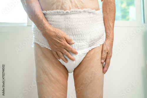 Asian senior woman patient wearing incontinence diaper in hospital, healthy strong medical concept.