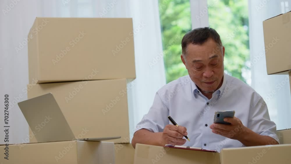 Asian elderly older using laptop and smartphone for checking email order at home office SMEs , Startup small business entrepreneur working online marketing after retirement, merchant seller concept Asian elderly older using laptop and smartphone for checking email order at home office SMEs , Startup small business entrepreneur working online marketing after retirement, merchant seller concept