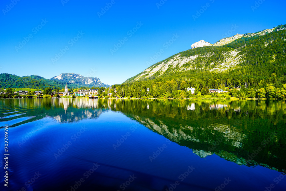Landscape at Lake Altaussee in the Salzkammergut in Austria. Idyllic nature by the lake in Styria. Altaussee at Totes Gebirge with a view of the surrounding mountains.
