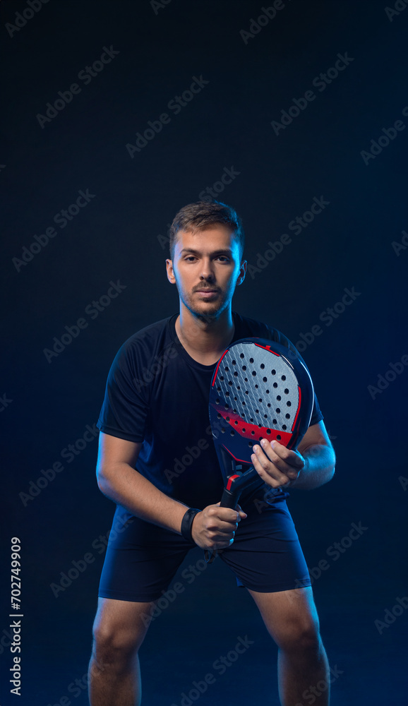 Padel tennis player in vertical social media template. Man athlete with paddle tenis racket on black background. Social media ads mockup. Thumb up.