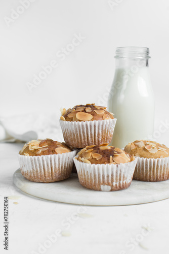 vanilla almond muffins on a white marble tray, homemade bakery style almond muffins on a white background	