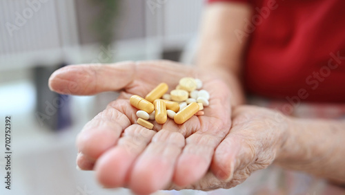 Old Woman's Hands With Pills And Capsules
