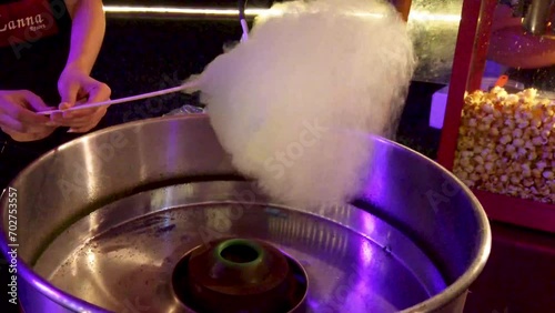 Making cotton candy or candy floss in street food market
