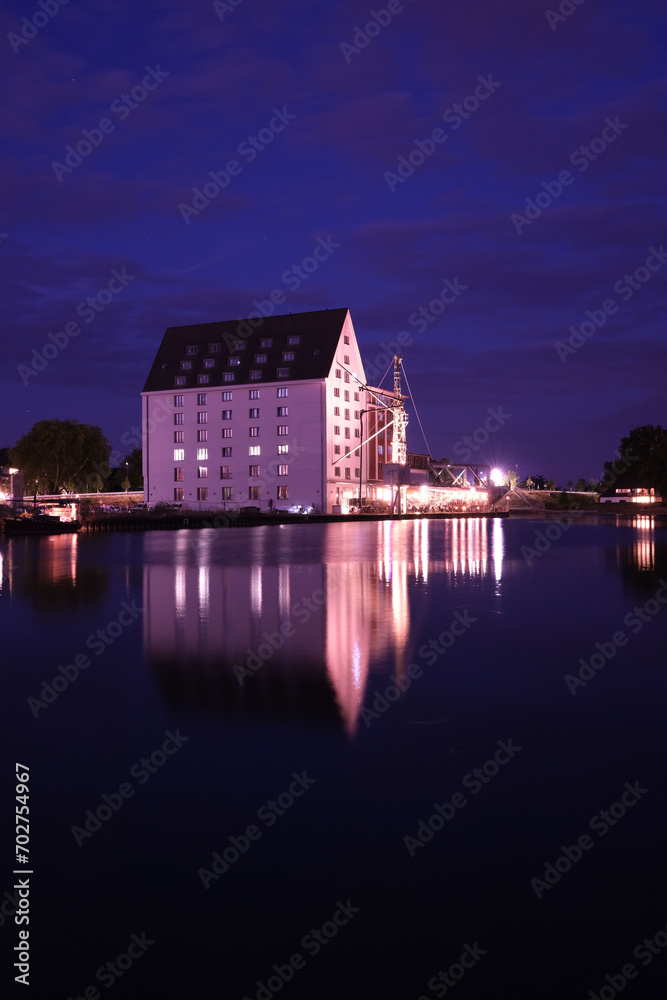 Old storehouse with white facade at night at the old harbour in Muenster in Westphalia, North Rhine-Westphalia Germany