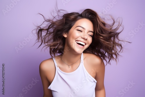 A cute and beautiful young female model with a playful and animated pose, capturing a lively and dynamic spirit, against a solid light purple background.