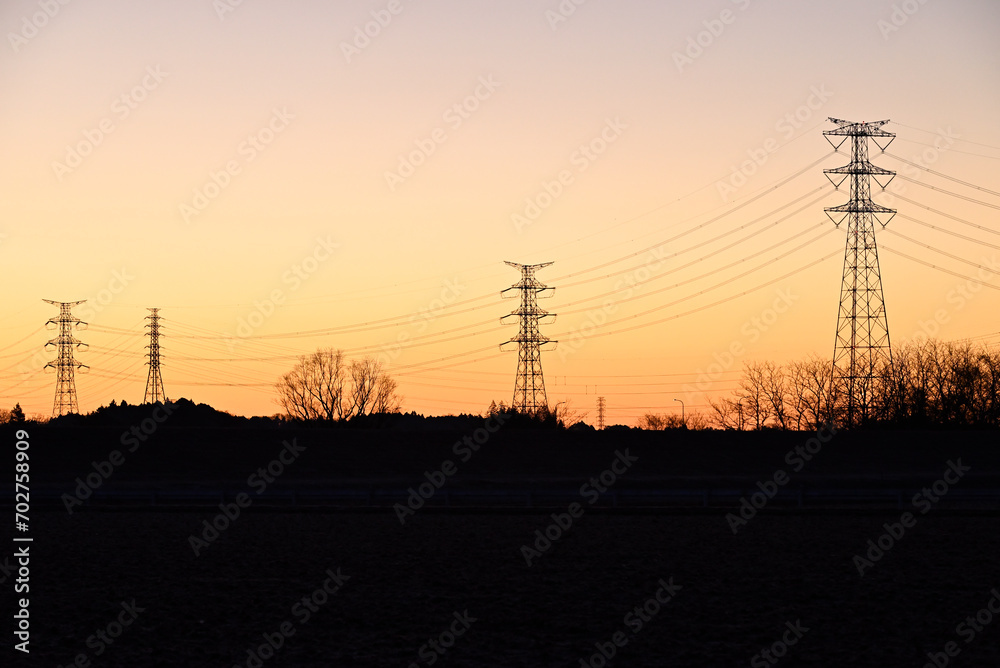Fototapeta premium Towers of power line in magic hour