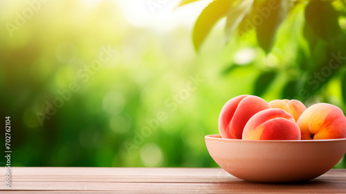 Peaches in a bowl in the garden. Selective focus. © Erik