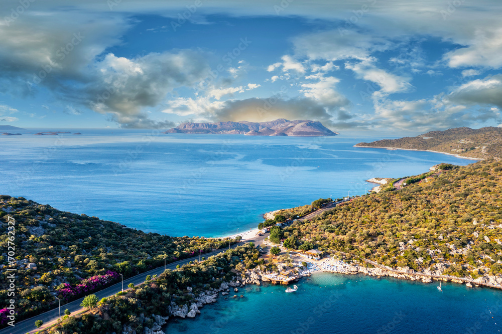 Aerial view of the touristic Kaş district and İnceboğaz beach with its lush green nature and deep blue sea. in the background the Greek island of Meis (Kastellorizo). Antalya, Turkey