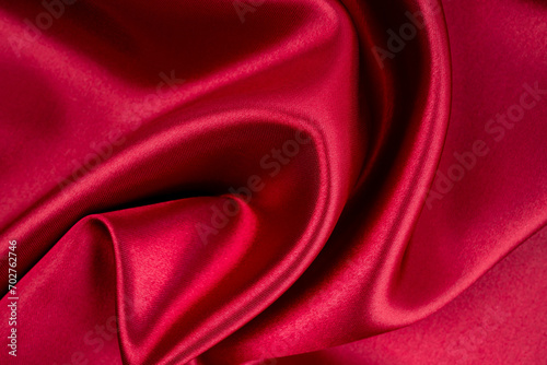 Red satin texture as background.