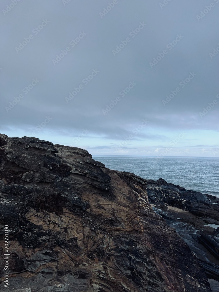 Rocks at the ocean coast, ocean bay, rocks, gray sky Rocks at the ocean coast, ocean bay, rocks, gray sky