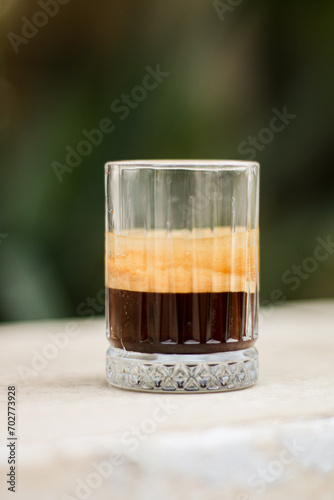 Chocolate cookie and Coffee in glass cup on rustic wooden background. Close up.