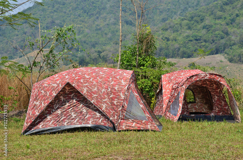 Thai people travelers travel visit and erect pitch tent for sleep rest in camping area Ban Taphoen Khi on Khao Thewada Mountain rest in camping area at Phu Toei National Park in Suphan Buri, Thailand photo