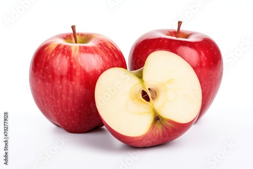  a close up of two apples with one cut in half and the other half in the shape of a heart.