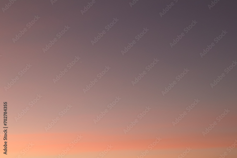 Morning star on the sky, soft pastel orange, pink and blue colors. Pink sky with early morning light.