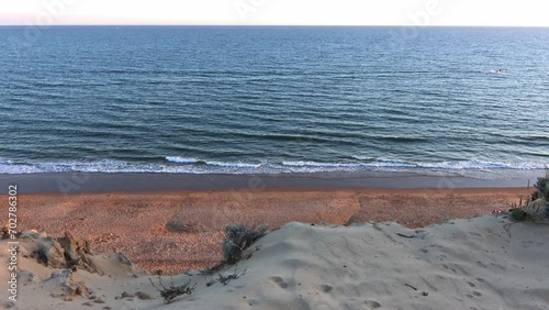 Arenosillo beach, located in Huelva, Spain. Explore the serene beauty of this coastal paradise with its sunlit sandy shores and the rhythmic ebb and flow of the Atlantic Ocean. photo