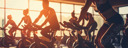 People in the gym on exercise machines. Selective focus.
