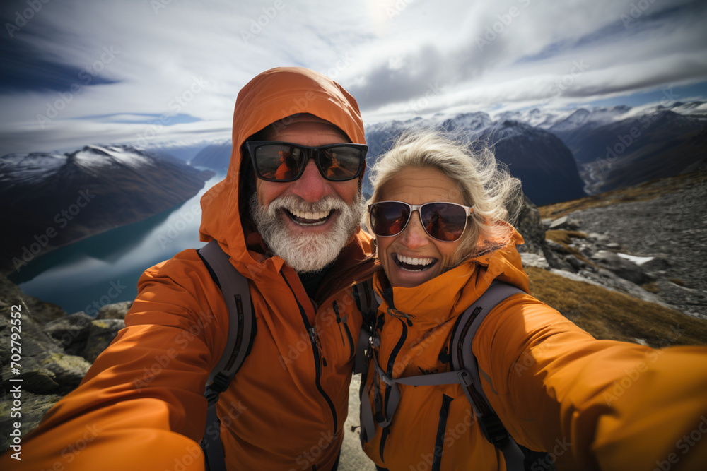 Cheerful mature active smiling mature couple enjoying time in winter cold mountains, happily retired. Romantic elderly still in love lifestyle time spending, family good relationship concept Cheerful mature active smiling mature couple enjoying time in winter cold mountains, happily retired. Romantic elderly still in love lifestyle time spending, family good relationship concept