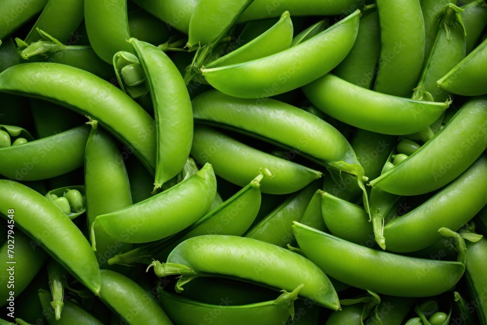 a pile of green peas sitting next to each other on top of a pile of other green pea's. a pile of green peas sitting next to each other on top of a pile of other green pea's.