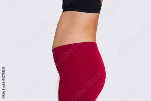 a profile picture of a young woman with a bulging stomach, suffering from bloating in the intestines, overeating. Incorrect posture and a bulging stomach photo