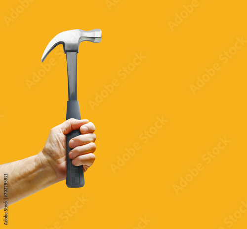 Man's hand holding hammer photo
